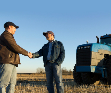 Banker Shaking Hands with Farmer